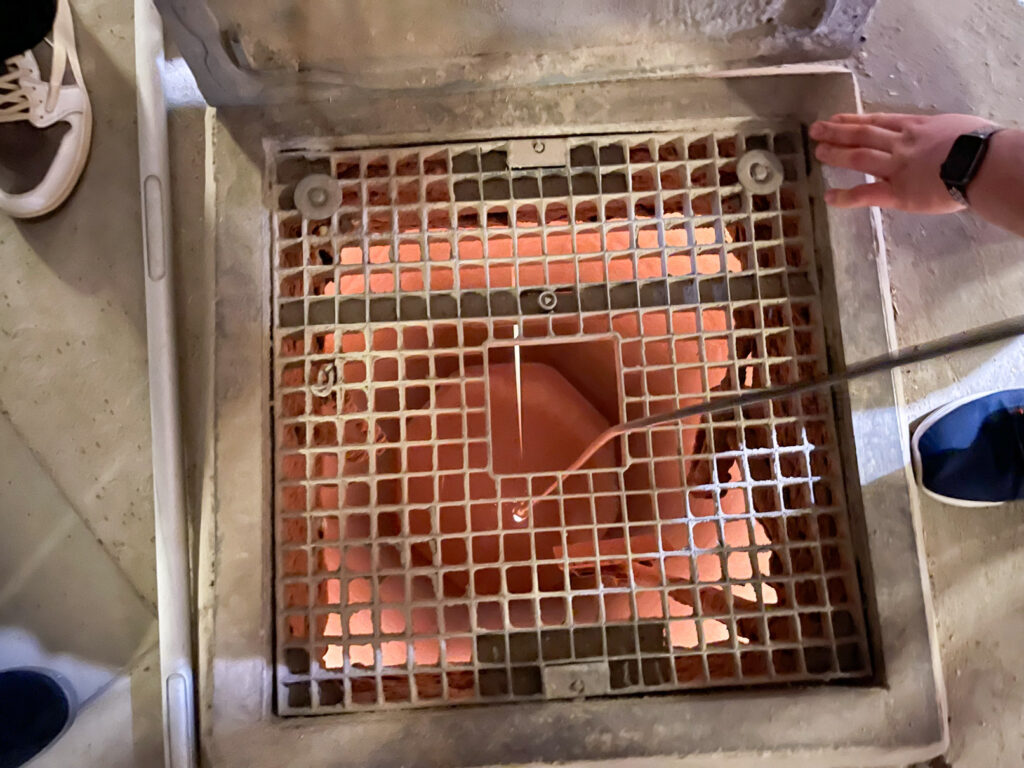 Mit-einer-Handlampe-wird-der-Füllstand-einer-Silozelle-überprüft